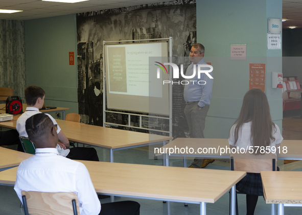   Year 10 pupils watch on as the head teacher gives a presentation. Ortu Gable Hall School in Corringham, Essex return after a long break du...