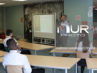   Year 10 pupils watch on as the head teacher gives a presentation. Ortu Gable Hall School in Corringham, Essex return after a long break du...