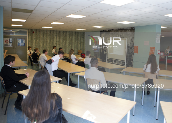   Year 10 pupils watch on as the head teacher gives a presentation. Ortu Gable Hall School in Corringham, Essex return after a long break du...