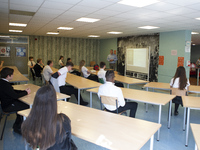   Year 10 pupils watch on as the head teacher gives a presentation. Ortu Gable Hall School in Corringham, Essex return after a long break du...