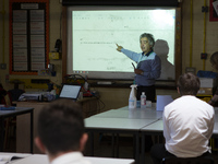   Year 10 pupils watch on as the teacher points to the whiteboard . Ortu Gable Hall School in Corringham, Essex return after a long break du...