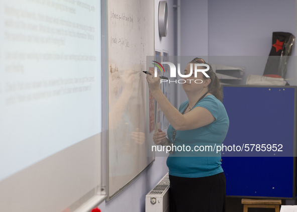  A teacher at the front of a class of Year 10 pupils. Ortu Gable Hall School in Corringham, Essex return after a long break due to the COVID...