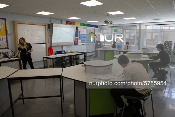  A teacher at the front of a class of Year 10 pupils . Ortu Gable Hall School in Corringham, Essex return after a long break due to the COVI...