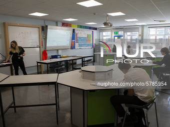  A teacher at the front of a class of Year 10 pupils . Ortu Gable Hall School in Corringham, Essex return after a long break due to the COVI...