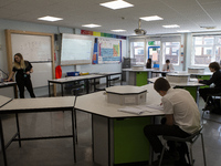  A teacher at the front of a class of Year 10 pupils . Ortu Gable Hall School in Corringham, Essex return after a long break due to the COVI...