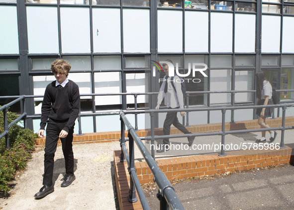   Year 10 pupils walking a long the path to get into the canteen for their break. Ortu Gable Hall School in Corringham, Essex return after a...