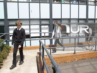   Year 10 pupils walking a long the path to get into the canteen for their break. Ortu Gable Hall School in Corringham, Essex return after a...