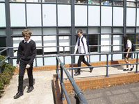   Year 10 pupils walking a long the path to get into the canteen for their break. Ortu Gable Hall School in Corringham, Essex return after a...