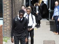   Year 10 pupils walking a long the path to get into the canteen for their break. Ortu Gable Hall School in Corringham, Essex return after a...