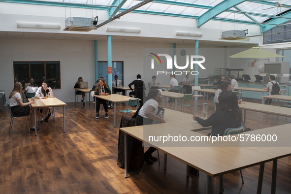   A general view of Year 10 pupils taking their break in the canteen. Ortu Gable Hall School in Corringham, Essex return after a long break...