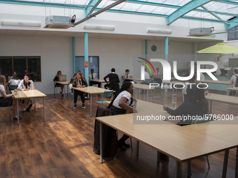   A general view of Year 10 pupils taking their break in the canteen. Ortu Gable Hall School in Corringham, Essex return after a long break...