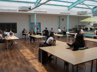   A general view of Year 10 pupils taking their break in the canteen. Ortu Gable Hall School in Corringham, Essex return after a long break...