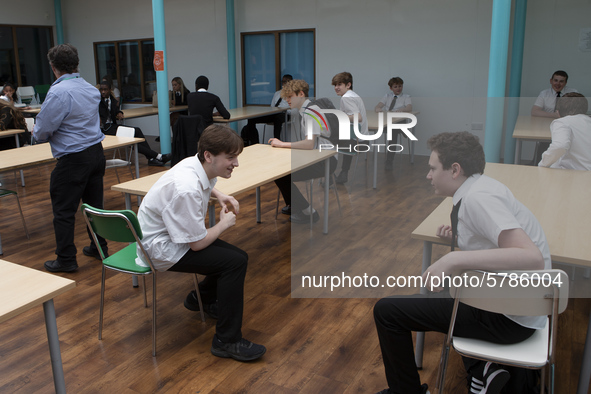   A general view of Year 10 pupils taking their break in the canteen. Ortu Gable Hall School in Corringham, Essex return after a long break...