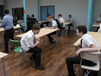   A general view of Year 10 pupils taking their break in the canteen. Ortu Gable Hall School in Corringham, Essex return after a long break...