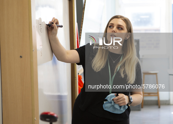  A teacher at the front of a class of Year 10 pupils . Ortu Gable Hall School in Corringham, Essex return after a long break due to the COVI...