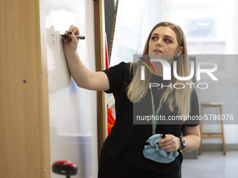  A teacher at the front of a class of Year 10 pupils . Ortu Gable Hall School in Corringham, Essex return after a long break due to the COVI...