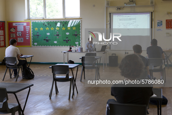   A teacher at the front of a class of Year 12 pupils. Ortu Gable Hall School in Corringham, Essex return after a long break due to the COVI...