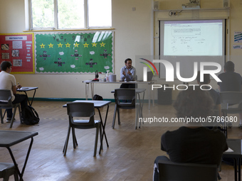   A teacher at the front of a class of Year 12 pupils. Ortu Gable Hall School in Corringham, Essex return after a long break due to the COVI...