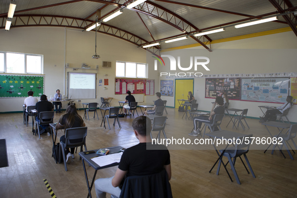   A teacher at the front of a class of Year 12 pupils. Ortu Gable Hall School in Corringham, Essex return after a long break due to the COVI...