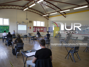   A teacher at the front of a class of Year 12 pupils. Ortu Gable Hall School in Corringham, Essex return after a long break due to the COVI...