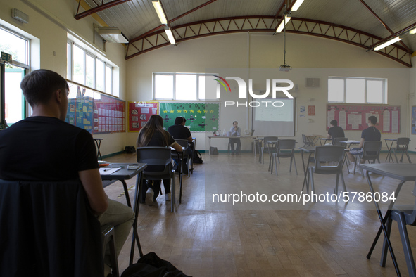   A teacher at the front of a class of Year 12 pupils. Ortu Gable Hall School in Corringham, Essex return after a long break due to the COVI...