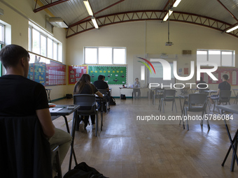   A teacher at the front of a class of Year 12 pupils. Ortu Gable Hall School in Corringham, Essex return after a long break due to the COVI...