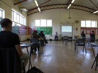   A teacher at the front of a class of Year 12 pupils. Ortu Gable Hall School in Corringham, Essex return after a long break due to the COVI...