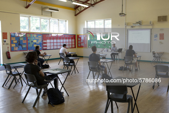   A teacher at the front of a class of Year 12 pupils. Ortu Gable Hall School in Corringham, Essex return after a long break due to the COVI...