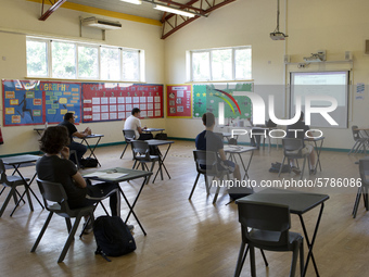   A teacher at the front of a class of Year 12 pupils. Ortu Gable Hall School in Corringham, Essex return after a long break due to the COVI...