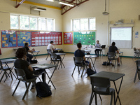   A teacher at the front of a class of Year 12 pupils. Ortu Gable Hall School in Corringham, Essex return after a long break due to the COVI...