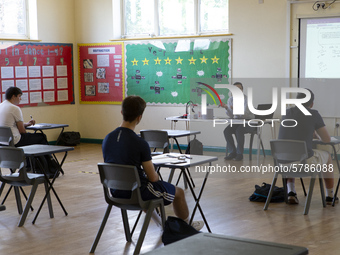   A teacher at the front of a class of Year 12 pupils. Ortu Gable Hall School in Corringham, Essex return after a long break due to the COVI...