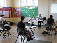   A teacher at the front of a class of Year 12 pupils. Ortu Gable Hall School in Corringham, Essex return after a long break due to the COVI...