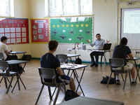   A teacher at the front of a class of Year 12 pupils. Ortu Gable Hall School in Corringham, Essex return after a long break due to the COVI...