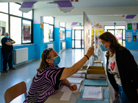 An employee of the Don Tonino Bello High School in Molfetta, Italy measures the temperature of the students who enter during the State Exams...