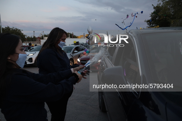 Ciudad Juarez High school students receive their diplomas inside their vehicles at a ''drive in'' graduation ceremony held at the Centro Cul...