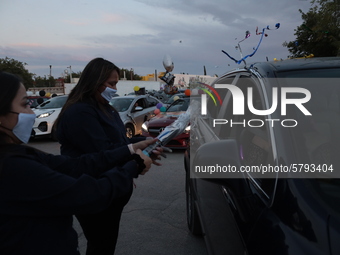 Ciudad Juarez High school students receive their diplomas inside their vehicles at a ''drive in'' graduation ceremony held at the Centro Cul...