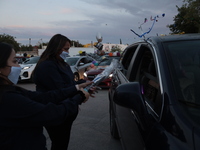 Ciudad Juarez High school students receive their diplomas inside their vehicles at a ''drive in'' graduation ceremony held at the Centro Cul...