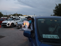 Ciudad Juarez High school students receive their diplomas inside their vehicles at a ''drive in'' graduation ceremony held at the Centro Cul...