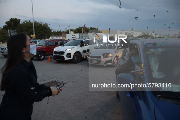 Ciudad Juarez High school students receive their diplomas inside their vehicles at a ''drive in'' graduation ceremony held at the Centro Cul...