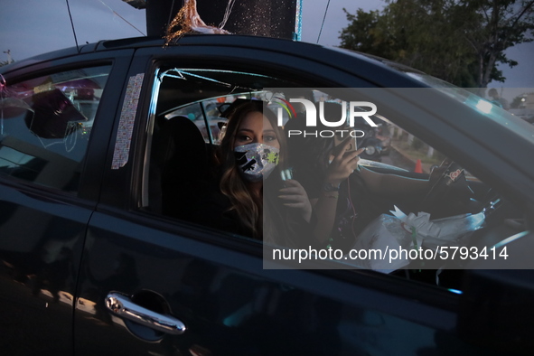 Ciudad Juarez High school students receive their diplomas inside their vehicles at a ''drive in'' graduation ceremony held at the Centro Cul...