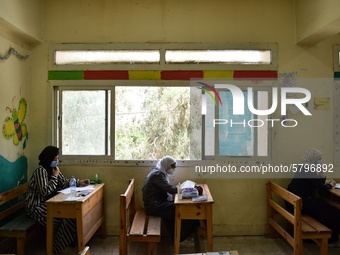 Egyptian high school students wear protective face masks as they attend the first day of final exams on June 21, 2020 in Cairo, Egypt. (