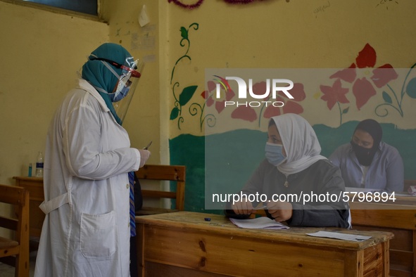 Egyptian high school students wear protective face masks as they attend the first day of final exams on June 21, 2020 in Cairo, Egypt. 