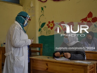 Egyptian high school students wear protective face masks as they attend the first day of final exams on June 21, 2020 in Cairo, Egypt. (