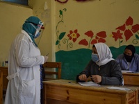 Egyptian high school students wear protective face masks as they attend the first day of final exams on June 21, 2020 in Cairo, Egypt. (