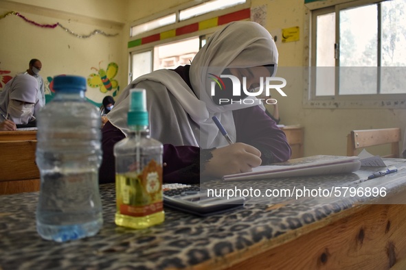 Egyptian high school students wear protective face masks as they attend the first day of final exams on June 21, 2020 in Cairo, Egypt. 