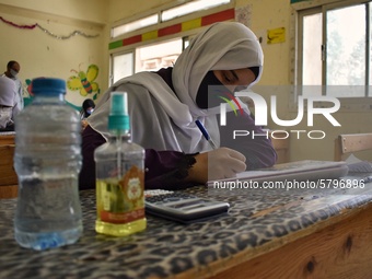 Egyptian high school students wear protective face masks as they attend the first day of final exams on June 21, 2020 in Cairo, Egypt. (