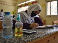 Egyptian high school students wear protective face masks as they attend the first day of final exams on June 21, 2020 in Cairo, Egypt. (