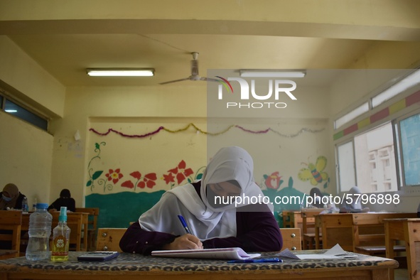 Egyptian high school students wear protective face masks as they attend the first day of final exams on June 21, 2020 in Cairo, Egypt. 