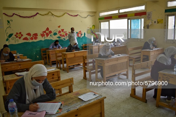 Egyptian high school students wear protective face masks as they attend the first day of final exams on June 21, 2020 in Cairo, Egypt. 