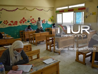 Egyptian high school students wear protective face masks as they attend the first day of final exams on June 21, 2020 in Cairo, Egypt. (